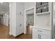 Walk-in pantry with custom shelving, a beverage fridge, and a view into the living room at 1724 Ridge Valley Nw Ct, Atlanta, GA 30327