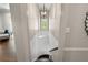 Bright and airy staircase features a modern light fixture at 1724 Ridge Valley Nw Ct, Atlanta, GA 30327