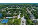 Aerial view of gated neighborhood with lake, pool, tennis courts, and homes at 981 Cranbrook Glen Ln, Snellville, GA 30078