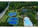 Aerial view of community swimming pool, tennis courts and nearby lake at 981 Cranbrook Glen Ln, Snellville, GA 30078