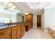 Elegant bathroom boasts granite countertops, a large mirror, and custom wood cabinets at 981 Cranbrook Glen Ln, Snellville, GA 30078
