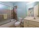 Well-maintained bathroom with shower-tub, tiled walls, toilet and vanity with sink at 981 Cranbrook Glen Ln, Snellville, GA 30078