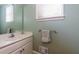 Neutral half-bathroom features a sleek mirror and faucet, plus a clean white sink and vanity at 981 Cranbrook Glen Ln, Snellville, GA 30078
