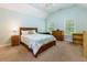 Bright bedroom with natural light, featuring light blue walls and wood furnishings at 981 Cranbrook Glen Ln, Snellville, GA 30078
