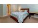 Bedroom with neutral carpeting and natural light; complemented by a wood bed frame and blue walls at 981 Cranbrook Glen Ln, Snellville, GA 30078