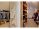 Spacious walk-in closet provides ample storage with built-in shelving and hanging racks at 981 Cranbrook Glen Ln, Snellville, GA 30078