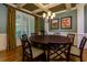 Sophisticated dining room with a round table, decorative chandelier, and large window at 981 Cranbrook Glen Ln, Snellville, GA 30078
