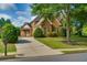 Beautiful two-story brick home with mature landscaping, large front yard, and long driveway at 981 Cranbrook Glen Ln, Snellville, GA 30078