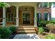 Inviting front entrance with brick steps, stately columns, and a double door entry at 981 Cranbrook Glen Ln, Snellville, GA 30078