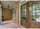 Charming front porch with brick flooring and a beautiful wood front door with glass panes at 981 Cranbrook Glen Ln, Snellville, GA 30078
