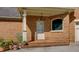 Charming brick front porch with decorative flower planters creating a cozy entryway at 981 Cranbrook Glen Ln, Snellville, GA 30078
