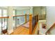 Beautiful upstairs hallway with hardwood floors and railing overlooking the great room at 981 Cranbrook Glen Ln, Snellville, GA 30078