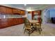 Bright kitchen with dark wood cabinetry, granite countertops, and stainless steel appliances at 981 Cranbrook Glen Ln, Snellville, GA 30078