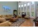 Inviting living room with a two-story window feature, hardwood floors, and comfortable seating arrangements at 981 Cranbrook Glen Ln, Snellville, GA 30078