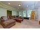 Cozy living room area features plush seating, natural light, and a decorative area rug at 981 Cranbrook Glen Ln, Snellville, GA 30078