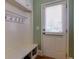 Practical mudroom area with coat hooks, bench, and storage at 981 Cranbrook Glen Ln, Snellville, GA 30078