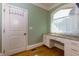 Functional mudroom with built-in desk, granite countertop, and storage at 981 Cranbrook Glen Ln, Snellville, GA 30078
