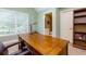 Spacious office features a large wooden desk, natural light, and built-in bookshelves at 981 Cranbrook Glen Ln, Snellville, GA 30078