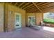 Covered brick patio with lounge chair overlooking the backyard at 981 Cranbrook Glen Ln, Snellville, GA 30078