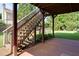 Spacious covered patio with stairs to backyard lawn and garden at 981 Cranbrook Glen Ln, Snellville, GA 30078