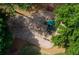 Aerial view of a playground with a swing set and slide surrounded by trees at 981 Cranbrook Glen Ln, Snellville, GA 30078