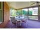 Inviting screened porch with seating and wooded views, perfect for enjoying the outdoors at 981 Cranbrook Glen Ln, Snellville, GA 30078