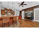Entertaining space with a full bar, hardwood floors, and a decorative brick wall at 5355 Avonshire Ln, Cumming, GA 30040