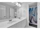 Bathroom with double sinks, white cabinets, and a shower with a unique curtain at 5355 Avonshire Ln, Cumming, GA 30040