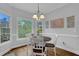 Bright dining area with a window view and modern chandelier at 5355 Avonshire Ln, Cumming, GA 30040