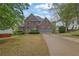 Beautiful two-story brick home with a manicured lawn and a spacious two-car garage at 5355 Avonshire Ln, Cumming, GA 30040