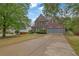 Charming two-story brick home with a well-manicured lawn and a spacious driveway at 5355 Avonshire Ln, Cumming, GA 30040