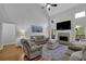 Bright living room with a fireplace, large windows, and a cozy seating area at 5355 Avonshire Ln, Cumming, GA 30040