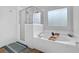 Bright main bathroom features garden tub with separate shower and patterned window at 5355 Avonshire Ln, Cumming, GA 30040