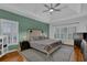 Spacious main bedroom with tray ceiling, ceiling fan and two large windows at 5355 Avonshire Ln, Cumming, GA 30040