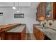 Wet bar featuring a granite countertop, wood cabinets, and a sink at 5355 Avonshire Ln, Cumming, GA 30040