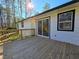 A large wooden back deck with sliding glass door leads to the backyard at 621 Hood Rd, Stockbridge, GA 30281