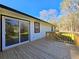 The back of the house has a wooden deck and sliding glass door to the lush backyard and mature trees at 621 Hood Rd, Stockbridge, GA 30281