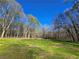 Expansive backyard featuring lush greenery and tall trees, perfect for outdoor activities at 621 Hood Rd, Stockbridge, GA 30281