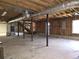 Unfinished basement with concrete floor, exposed ceiling, and support beams shows potential for customization at 621 Hood Rd, Stockbridge, GA 30281