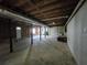 Unfinished basement space with potential for storage, featuring exposed utilities and support beams at 621 Hood Rd, Stockbridge, GA 30281