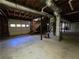 Large unfinished basement with garage door access, offering potential for storage or expansion at 621 Hood Rd, Stockbridge, GA 30281