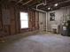 Unfinished basement featuring a utility sink, hot water heater, and exposed wood frame walls at 621 Hood Rd, Stockbridge, GA 30281