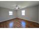 Cozy bedroom with hardwood flooring, ceiling fan, and double-hung windows at 621 Hood Rd, Stockbridge, GA 30281