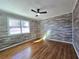 Comfortable bedroom with hardwood floors, ceiling fan, and a large window at 621 Hood Rd, Stockbridge, GA 30281