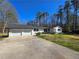 View of the home, two-car garage, and concrete driveway at 621 Hood Rd, Stockbridge, GA 30281