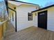 Side exterior view featuring a modern deck with a dark front door and trim at 621 Hood Rd, Stockbridge, GA 30281