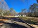 Charming single-story home with a long driveway and a well-maintained front yard at 621 Hood Rd, Stockbridge, GA 30281