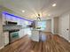 Modern kitchen with white cabinets, stainless steel appliances, and an island with a sink at 621 Hood Rd, Stockbridge, GA 30281