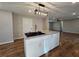 Kitchen island with a sink, granite countertops, and hardwood floors at 621 Hood Rd, Stockbridge, GA 30281