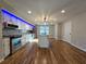 Spacious kitchen featuring modern appliances, an island with sink, and hardwood floors at 621 Hood Rd, Stockbridge, GA 30281